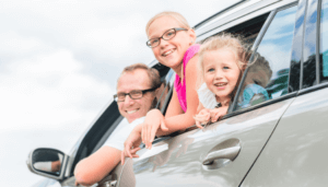Family inside vehicle in drive-by parade