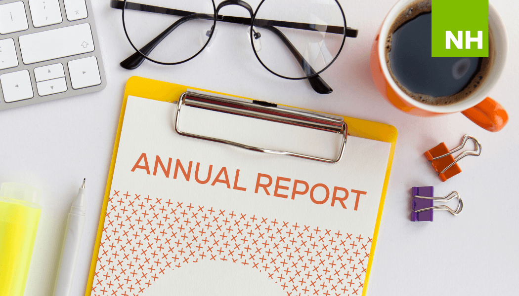 Clipboard with nonprofit annual report near coffee mug and glasses