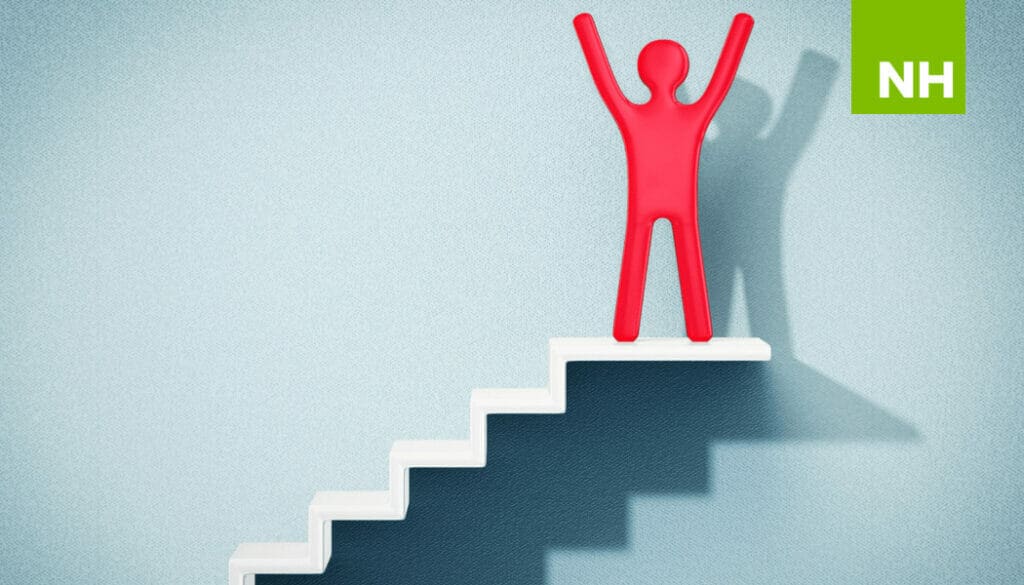 Figure standing on top of stairs with raised arms